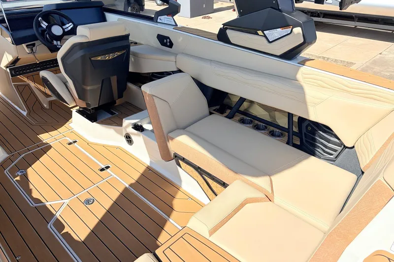 Slide: The Image of 2026 Nautique Super Air Nautique G23 interior with beige seating and modern dashboard. - 47