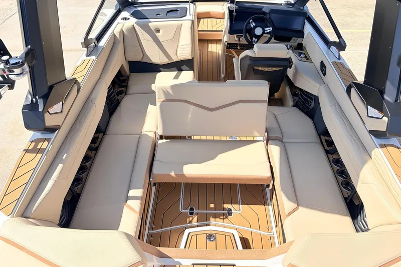 Slide: The Image of Luxurious interior of 2026 Nautique Super Air Nautique G23 boat with beige seating. - 40