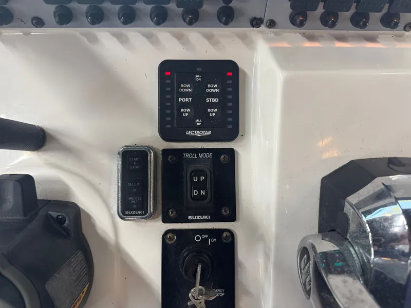 Slide: The Image of Close-up of the helm controls on a 2020 Sea Born LX24 Center Console boat. - 30