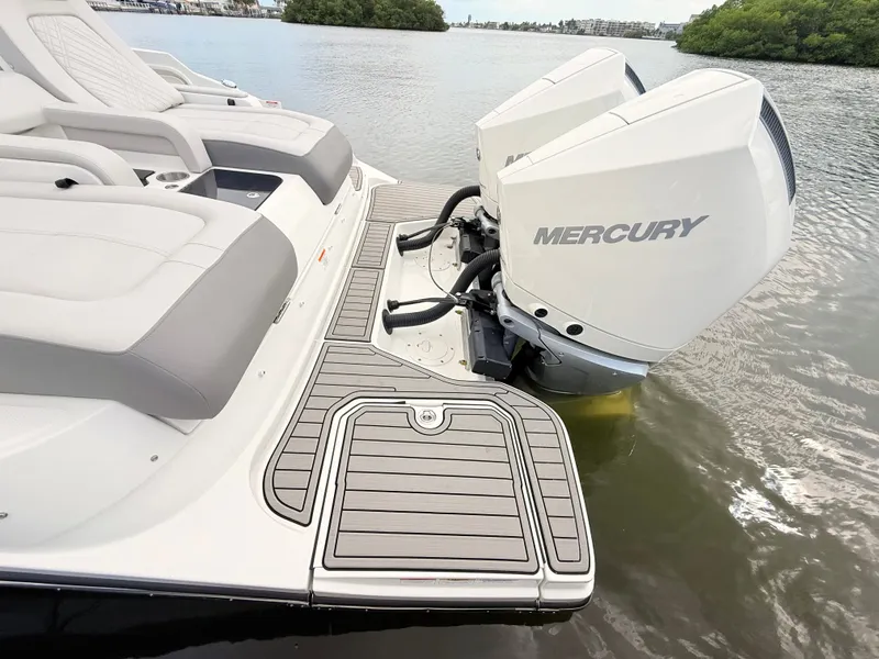 Slide: The Image of The image shows the stern of a Sea Ray SDX 290 Outboard with twin Mercury outboard engines. - 24