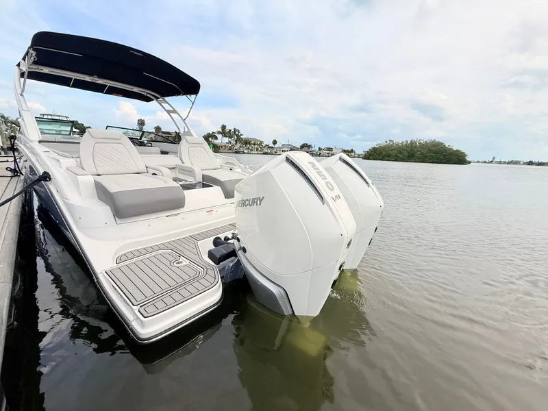 Slide: The Image of A 2027 Sea Ray SDX 290 Outboard is docked on the water. It features a sleek design with twin outboard engines. - 23