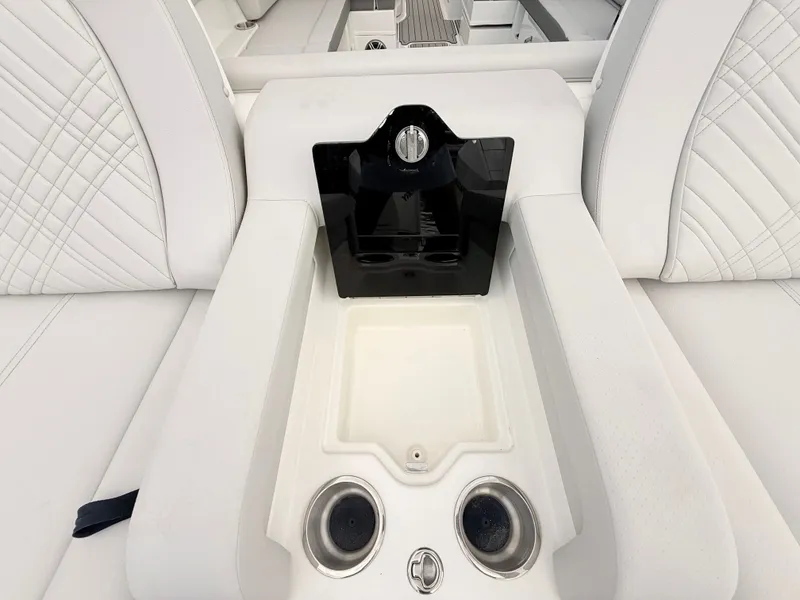Slide: The Image of The 2027 Sea Ray SDX 290 Outboard features elegant white upholstery with cup holders. - 30