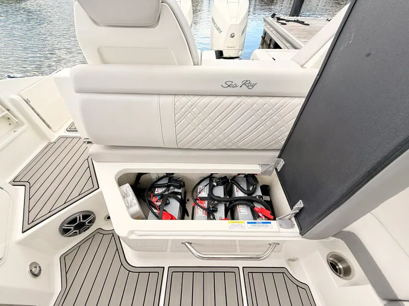 Slide: The Image of The image shows the seating area of a Sea Ray SDX 290 Outboard with a battery compartment. - 39