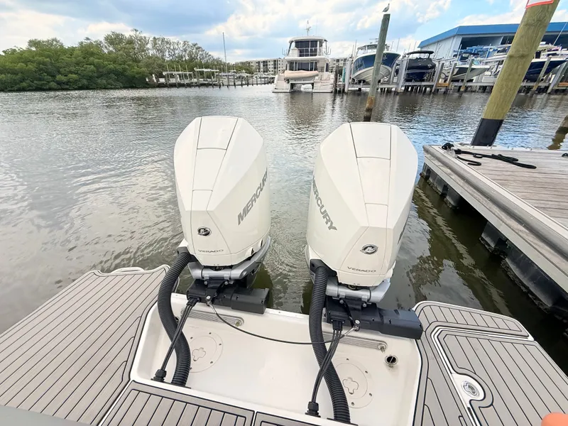 Slide: The Image of Two Mercury outboard engines on a Sea Ray SDX 290 boat docked in a calm marina. - 25