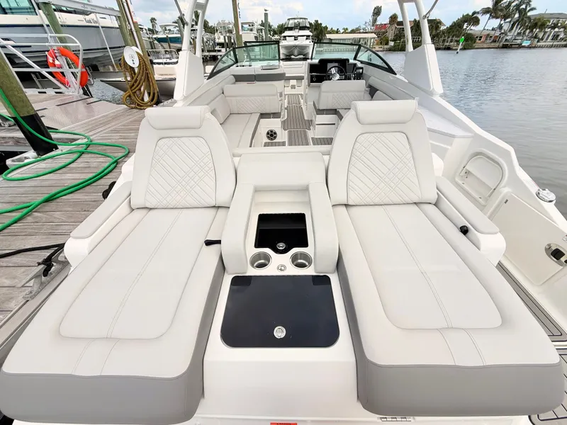 Slide: The Image of The image shows the spacious stern of a Sea Ray SDX 290 Outboard with luxurious seating. - 27