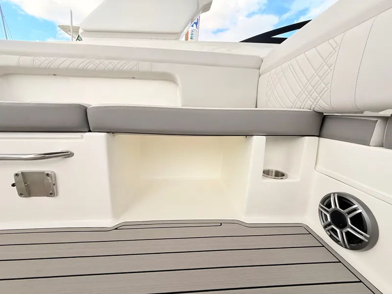 Slide: The Image of The image shows the cockpit of a 2027 Sea Ray SDX 290 Outboard with gray upholstery and wood flooring. - 48