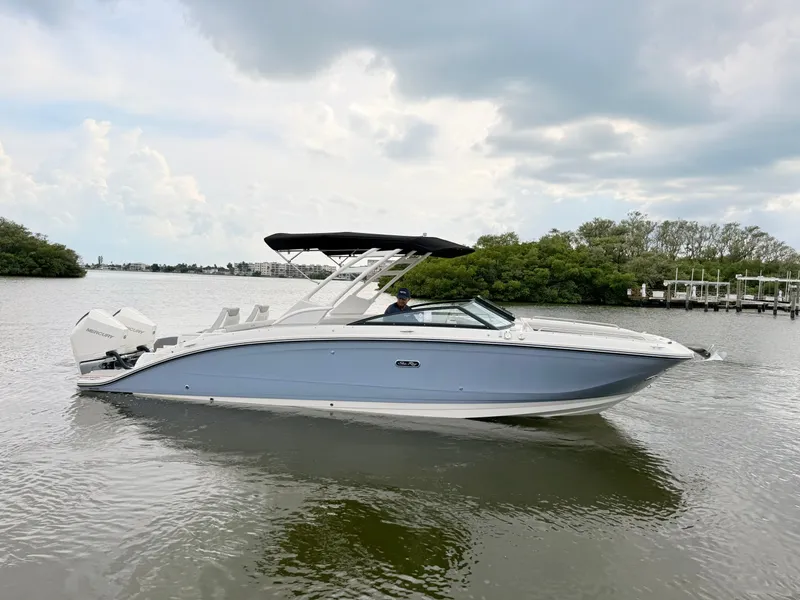 Slide: The Image of A 2027 Sea Ray SDX 290 Outboard on calm water with a cloudy sky. - 11