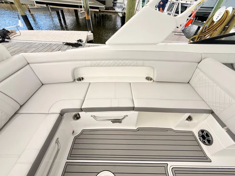 Slide: The Image of The image shows the sleek cockpit of a Sea Ray SDX 290 Outboard with gray upholstery and wood flooring. - 41