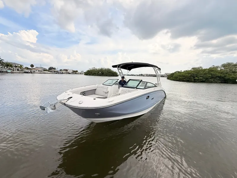 Slide: The Image of A 2027 Sea Ray SDX 290 Outboard cruising on calm waters under a cloudy sky. - 4