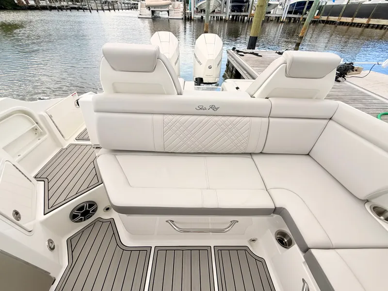 Slide: The Image of The image shows the stern of a Sea Ray SDX 290 Outboard with sleek white upholstery and gray flooring. - 38