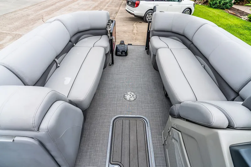 Slide: The Image of The image shows the interior of a Regency R230 DL3 pontoon boat with gray upholstery. - 8
