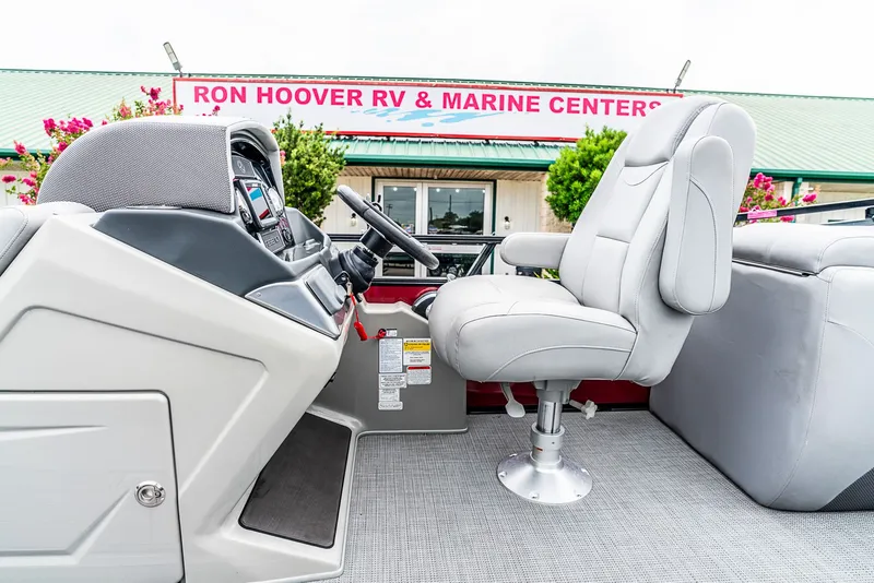 Slide: The Image of Interior view of a boat with a gray seat and steering console. - 9