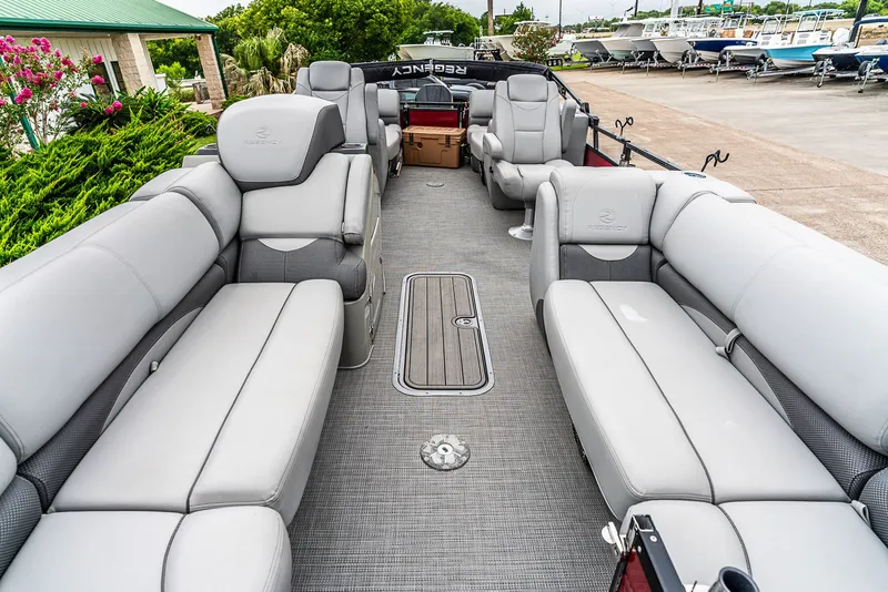 Slide: The Image of The image shows the interior of a 2022 Regency R230 DL3 pontoon boat with gray seating. - 5