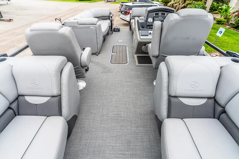 Slide: The Image of The image shows the interior of a 2022 Regency R230 DL3 boat with gray seating. - 6