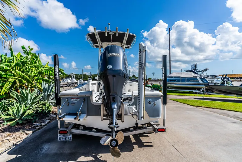 Slide: The Image of A 2016 Sea Hunt BX 20 BR boat with a powerful outboard motor, parked on a trailer. - 4