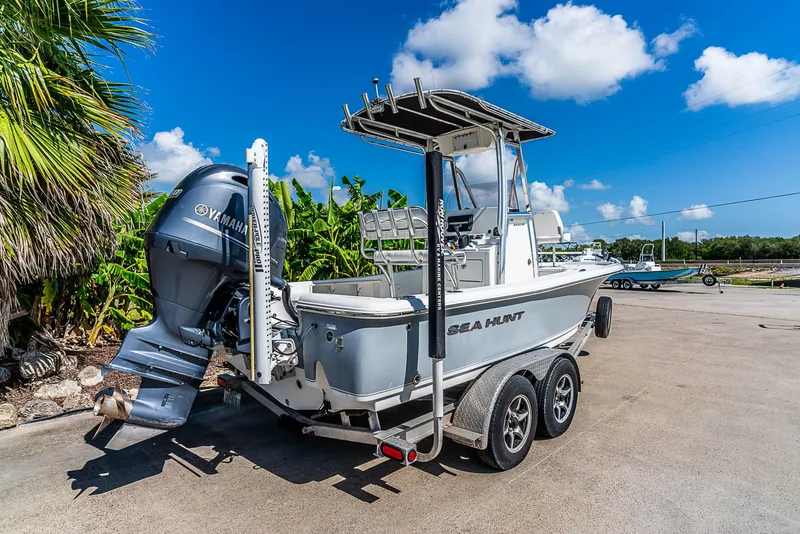Slide: The Image of 2016 Sea Hunt BX 20 BR on a trailer, surrounded by palm trees and blue sky. - 3