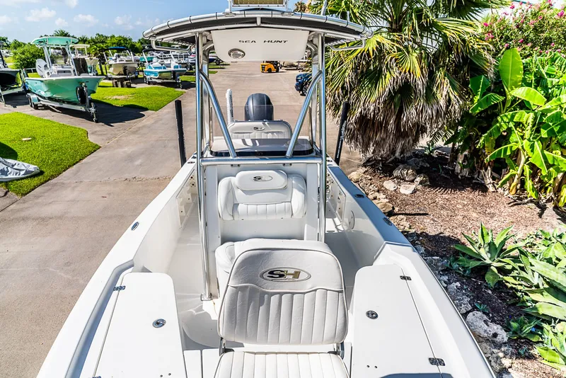 Slide: The Image of A 2016 Sea Hunt BX 20 BR boat on a trailer, surrounded by lush greenery. - 17