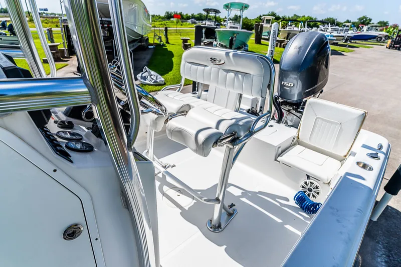 Slide: The Image of The image shows a 2016 Sea Hunt BX 20 BR boat with a clean, white cockpit and an outboard motor. - 10