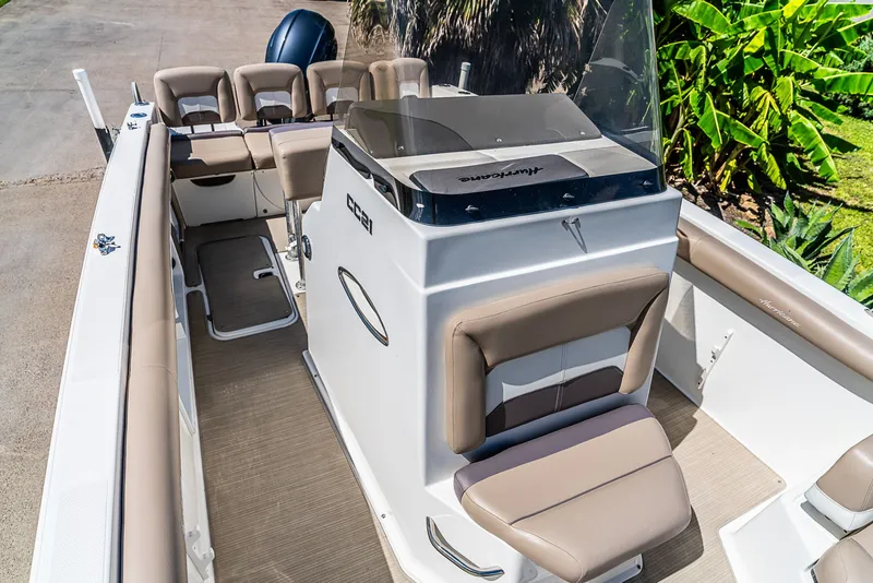 Slide: The Image of The image shows the cockpit of a 2016 Hurricane 21CC boat with beige seating. - 14