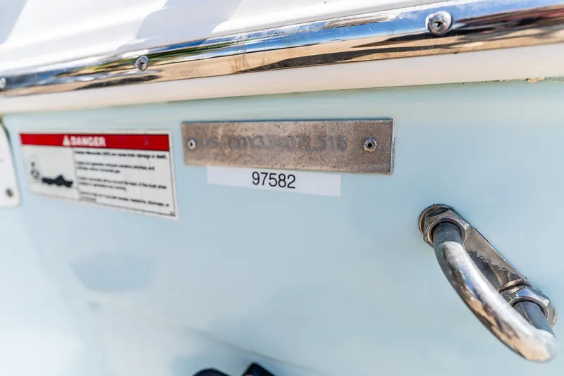 Slide: The Image of Close-up of a boat hull with warning label and handle. - 15