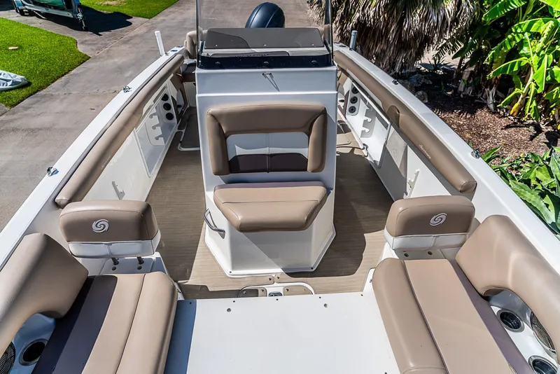 Slide: The Image of The image shows the deck of a 2016 Hurricane 21CC boat with beige seating. - 13