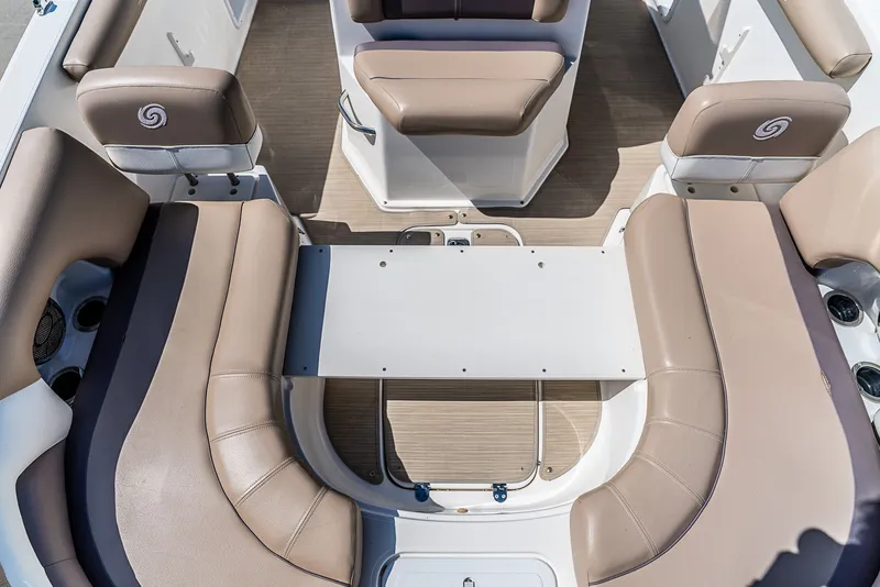 Slide: The Image of Interior of a 2016 Hurricane 21CC boat with beige seating and a table. - 12