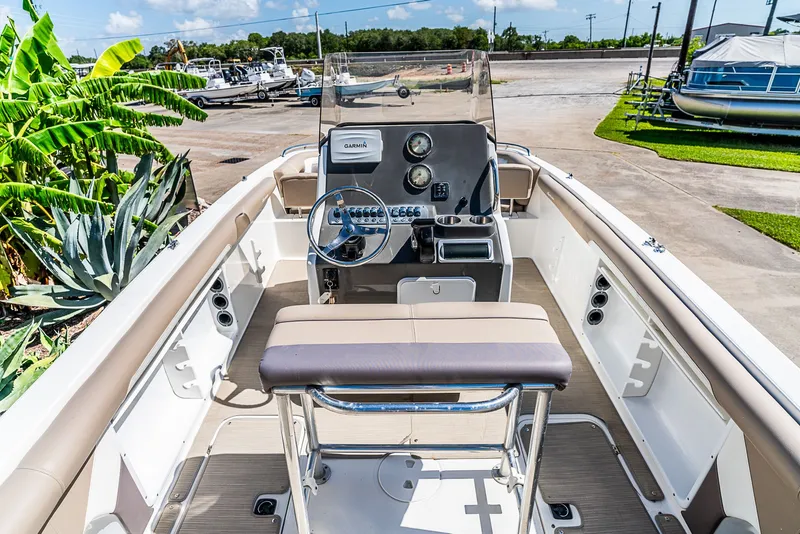 Slide: The Image of The image shows the cockpit of a 2016 Hurricane 21CC boat with a helm and seating. - 5