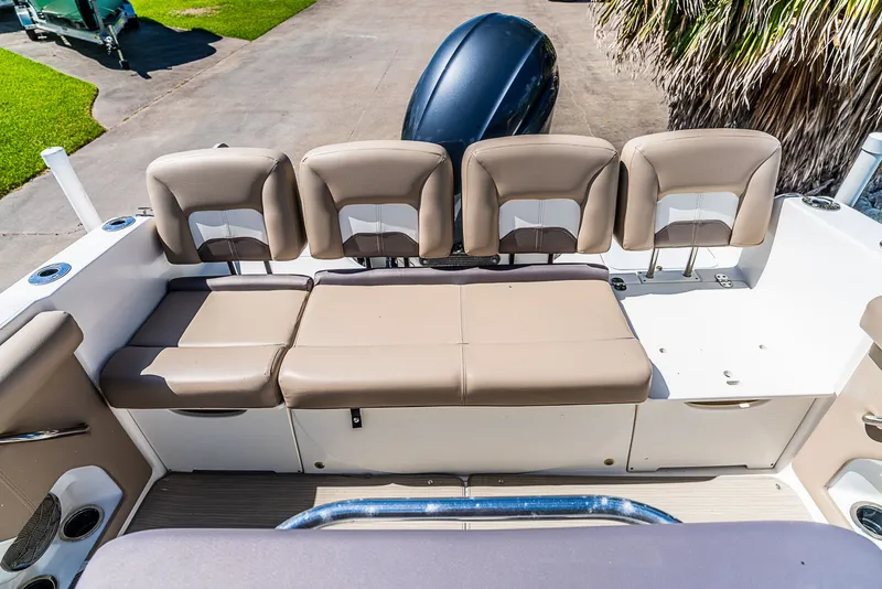 Slide: The Image of The 2016 Hurricane 21CC features a beige bench seat with backrests and storage underneath. - 7