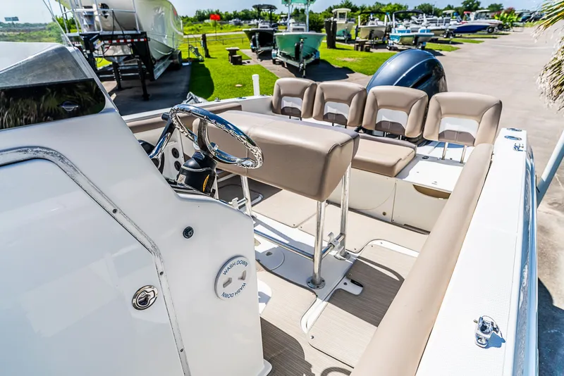 Slide: The Image of The image shows a 2016 Hurricane 21CC boat with beige seating and a helm station. - 8