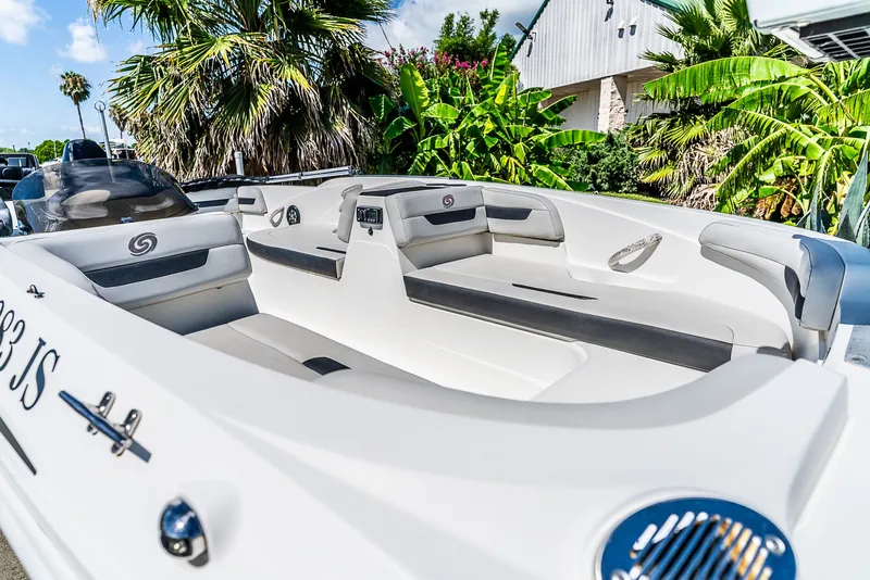 Slide: The Image of A 2020 Hurricane SS185 boat with white seating and palm trees in the background. - 5