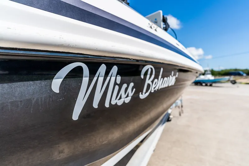 Slide: The Image of Close-up of the boat "Miss Behavin'" with a blue sky in the background. - 11