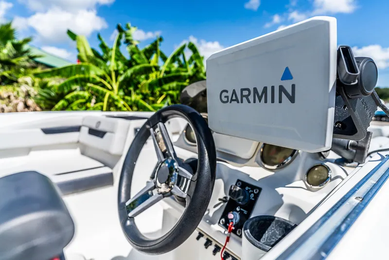 Slide: The Image of The image shows the cockpit of a Hurricane SS185 boat with a Garmin navigation system. - 12