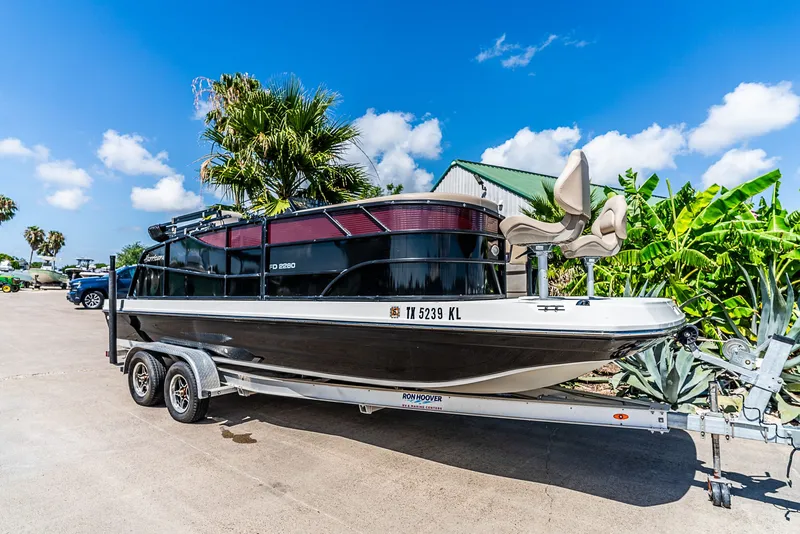 The Image of Hurricane FD2260F from 2022 on a trailer, surrounded by palm trees and blue sky. - 1