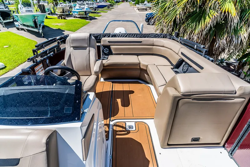Slide: The Image of The image shows the cockpit of a 2022 Hurricane FD2260F boat with beige seating. - 14