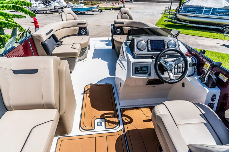 Slide: The Image of The image shows the cockpit of a 2022 Hurricane FD2260F boat with beige seating and a modern helm. - 9