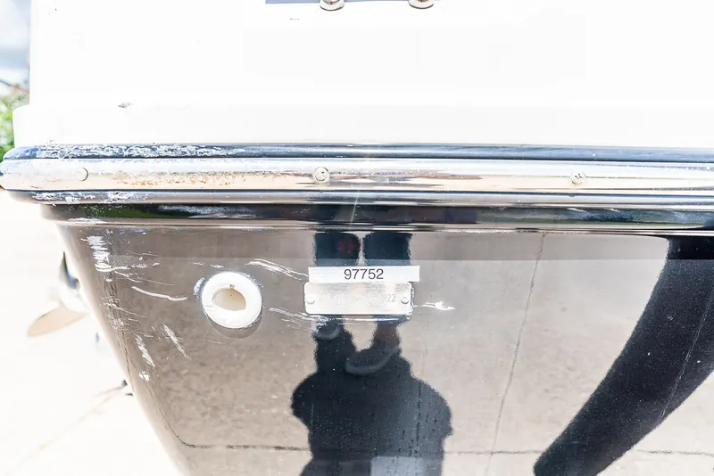 Slide: The Image of Close-up of a boat hull with scratches and a serial number. - 15