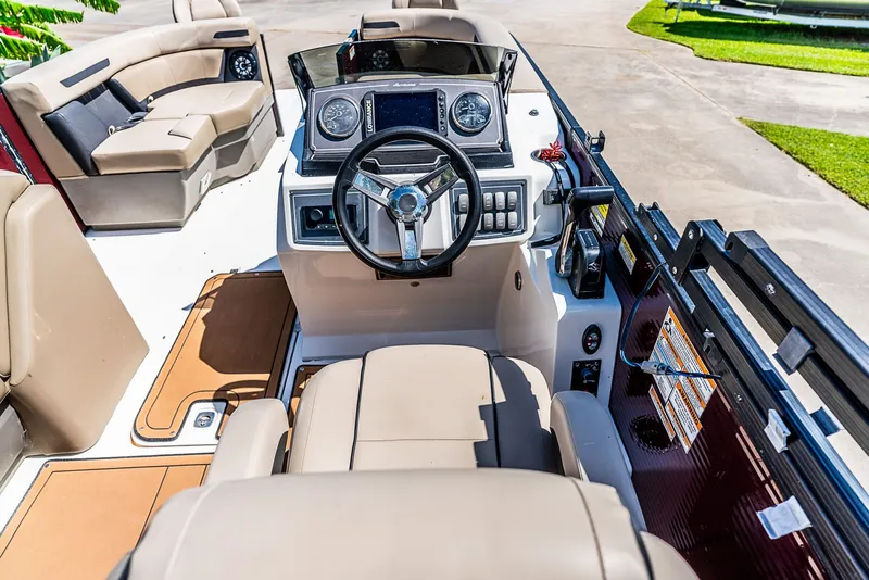 Slide: The Image of The image shows the cockpit of a 2022 Hurricane FD2260F boat with beige seats and a modern helm. - 7