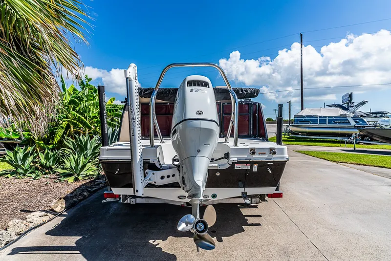 Slide: The Image of A 2022 Hurricane FD2260F boat on a trailer, surrounded by palm trees and blue sky. - 4