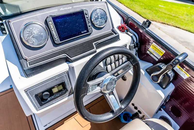 Slide: The Image of The image shows the helm of a 2022 Hurricane FD2260F boat with modern instruments. - 11