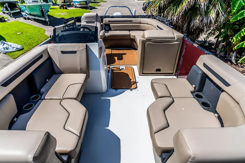 Slide: The Image of The image shows the spacious deck of a 2022 Hurricane FD2260F boat with beige seating. - 12