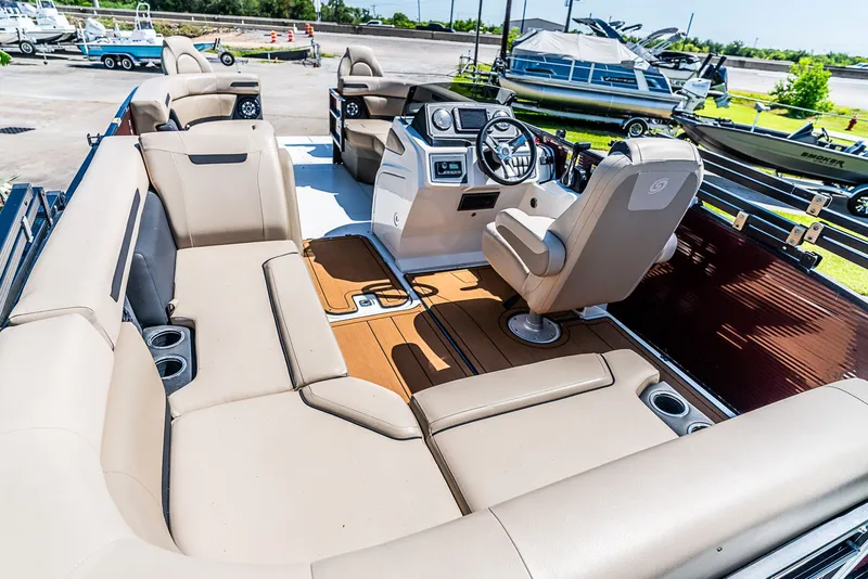 Slide: The Image of The image shows the cockpit of a 2022 Hurricane FD2260F boat with beige seating. - 6