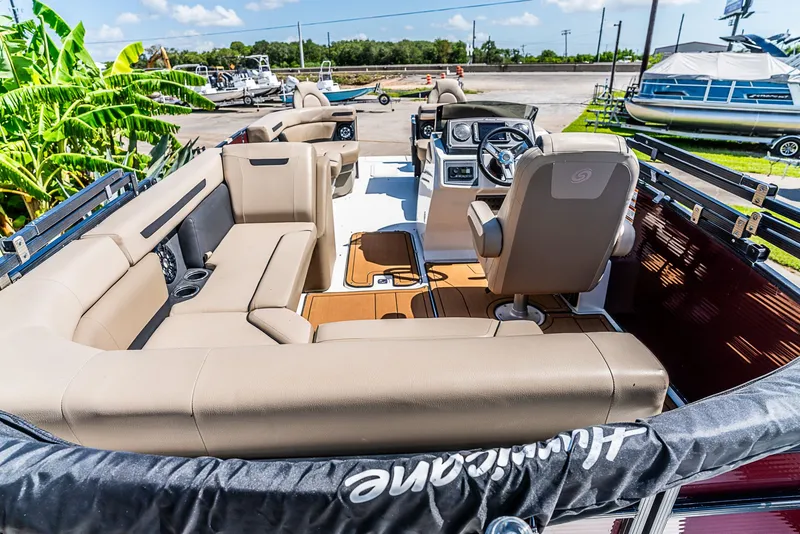 Slide: The Image of The image shows the interior of a 2022 Hurricane FD2260F boat with beige seating. - 5