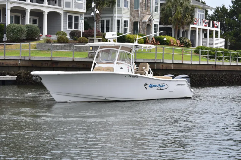 The Image of 2017 Sportsman Open 312 Center Console boat on water near waterfront homes. - 1