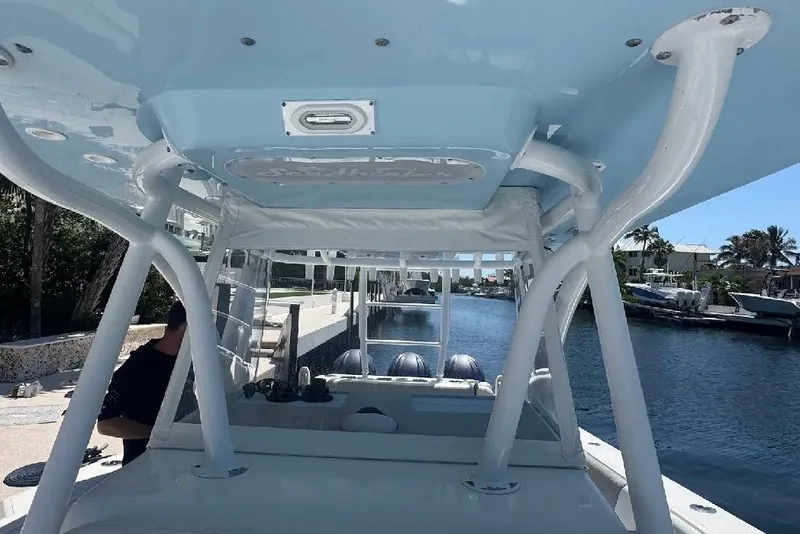 Slide: The Image of 2017 SeaHunter 35 Tournament boat docked, showcasing interior and waterway view. - 14