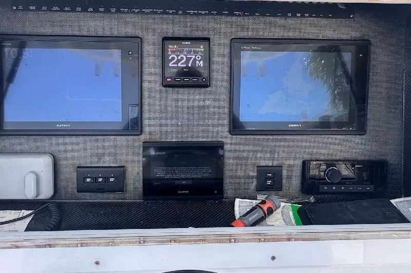 Slide: The Image of Control panel of a 2017 SeaHunter 35 Tournament with Garmin navigation displays. - 17