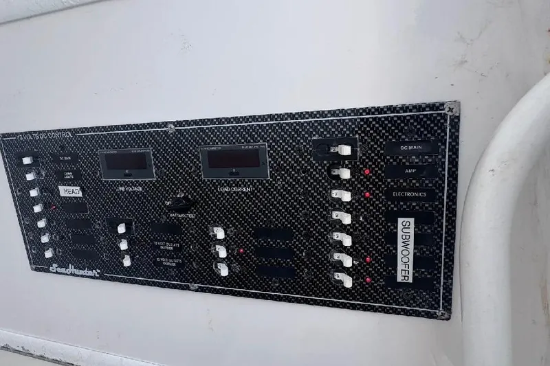 Slide: The Image of Control panel of a 2017 SeaHunter 35 Tournament boat, featuring various switches and indicators. - 25
