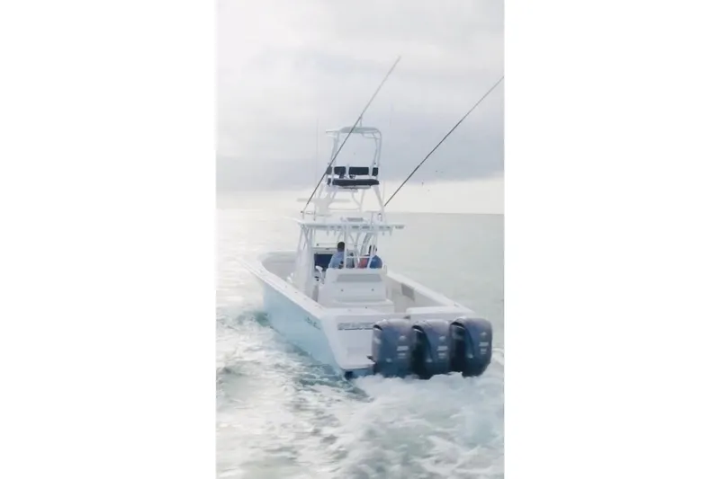 Slide: The Image of 2017 SeaHunter 35 Tournament boat cruising on open water with triple outboard engines. - 3