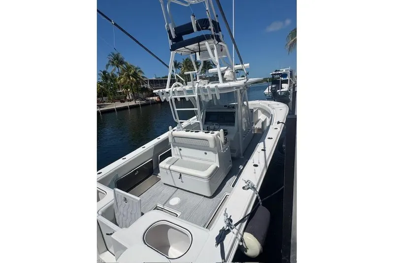 Slide: The Image of 2017 SeaHunter 35 Tournament boat docked, featuring spacious deck and seating. - 10