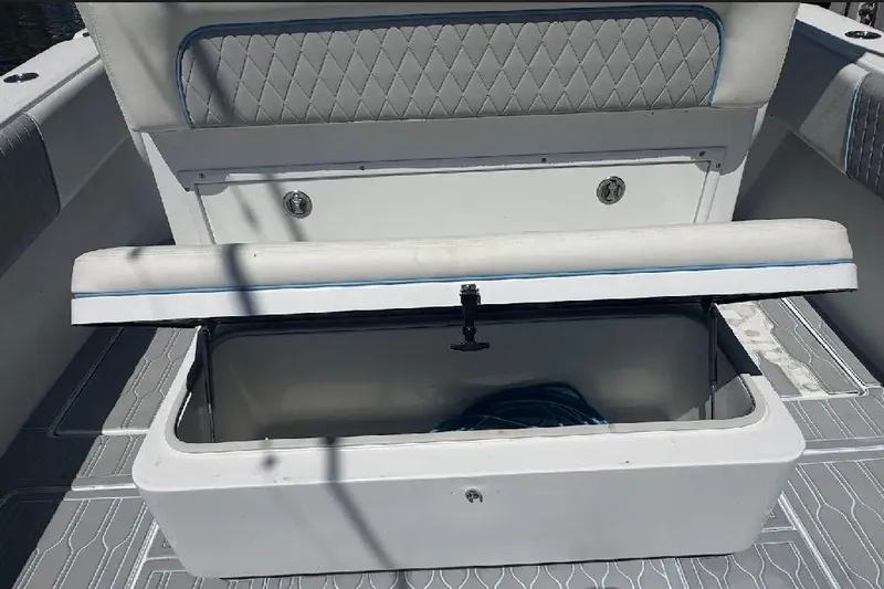Slide: The Image of 2017 SeaHunter 35 Tournament boat with open storage compartment and cushioned seating. - 16