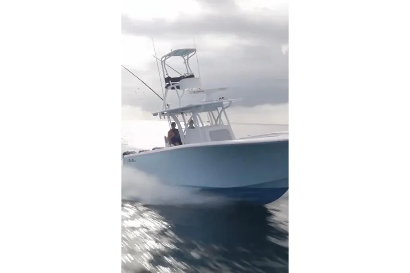 Slide: The Image of 2017 SeaHunter 35 Tournament boat cruising on open water under cloudy skies. - 7